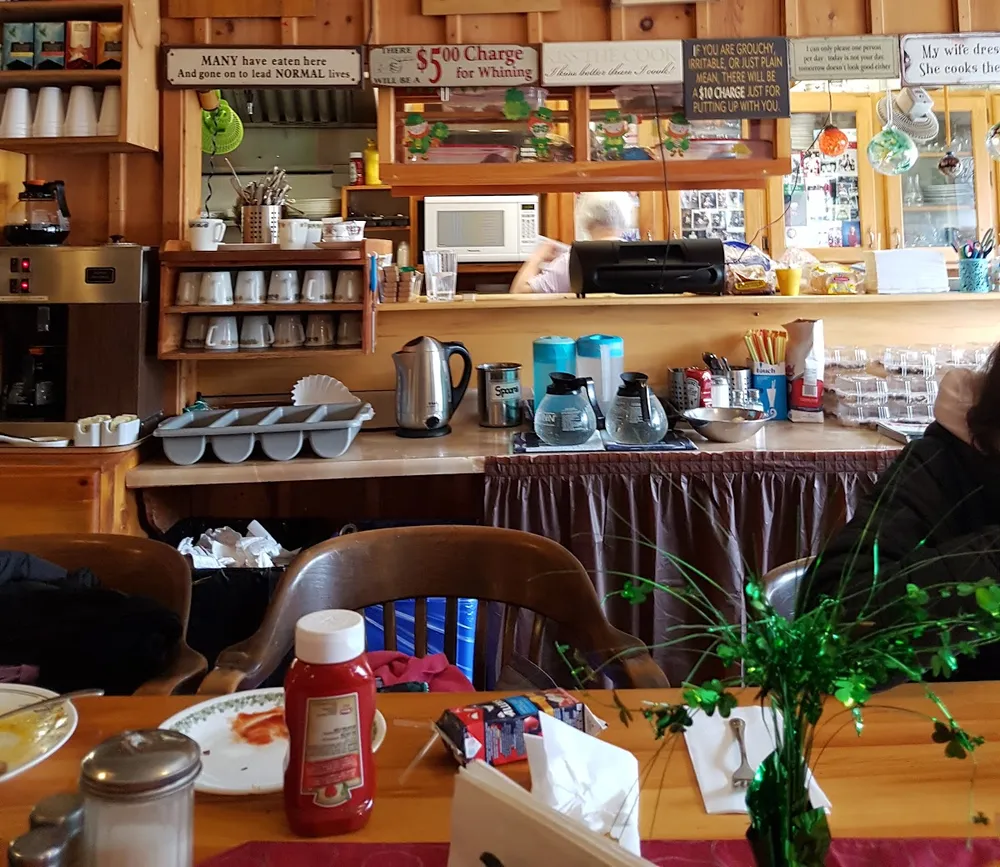 The kitchen pass with hand-painted signs above it