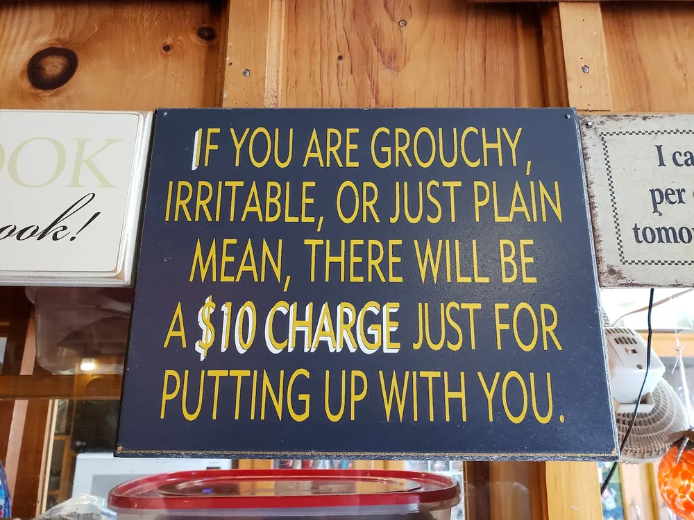 A sign: grouchy customers pay a $10 charge